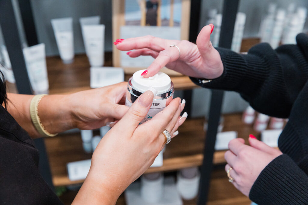 A woman is testing out a product to develop her skin care routine steps in Cedar Falls.