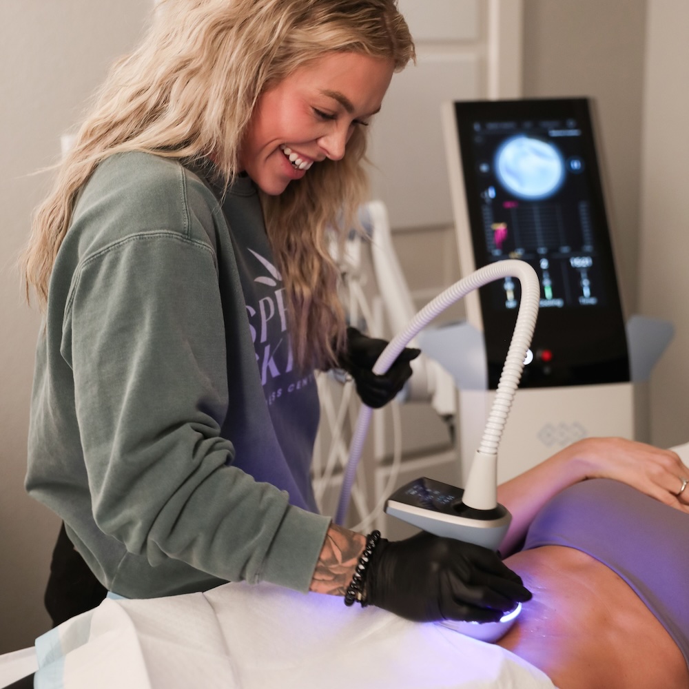 Med Spa provider places Exion body device on patient's stomach as a treatment option for how to get rid of cellulite in Waterloo