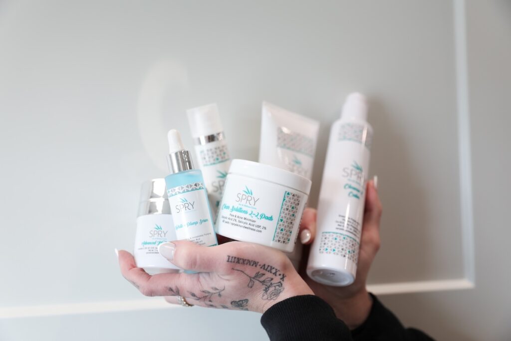 A Member of our team holds a handful of Spry Skincare Products.